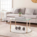 Table basse ronde à plateau en verre et cadre en fer doré